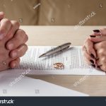 stock-photo-hands-of-wife-and-husband-signing-divorce-dissolution-canceling-marriage-legal-separation-488117365